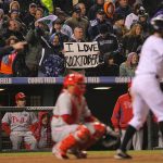 DENVER - OCTOBER 11:  Fans of the Colorado Rockies cheer for their team and hold up a sign which reads "I Love Rocktober" against the Philadelphia Phillies in Game Three of the NLDS during the 2009 MLB Playoffs at Coors Field on October 11, 2009 in Denver, Colorado.  (Photo by Doug Pensinger/Getty Images)