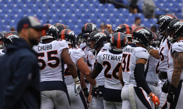 Denver Broncos quarterback Case Keenum #4 pulls in the team before their game against the Baltimore...