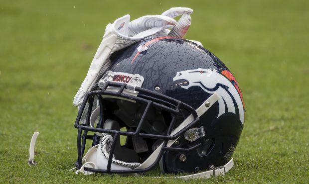 The helmet and gloves of Will Parks #34 of the Denver Broncos (not pictured) rests on the field bef...