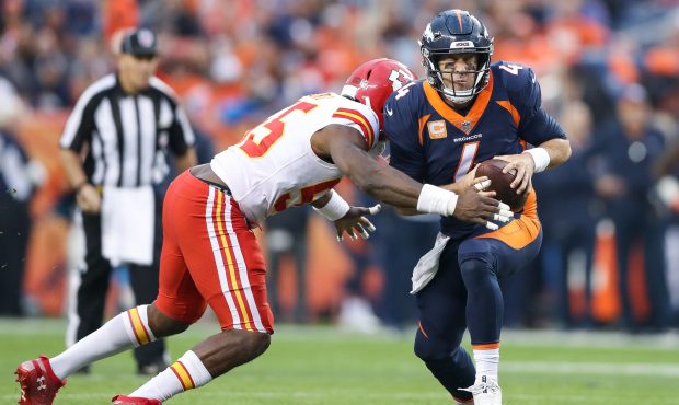 Quarterback Case Keenum #4 of the Denver Broncos is sacked by linebacker Dee Ford #55 of the Kansas...