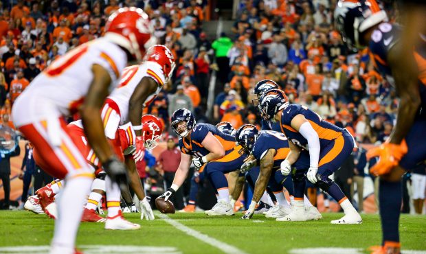 The Denver Broncos offense lines up behind center Matt Paradis #61 against the Kansas City Chiefs a...