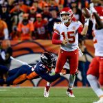 Quarterback Patrick Mahomes #15 of the Kansas City Chiefs throws a left-handed pass for a completion while he is hit by linebacker Von Miller #58 of the Denver Broncos in the fourth quarter of a game at Broncos Stadium at Mile High on October 1, 2018 in Denver, Colorado. (Photo by Dustin Bradford/Getty Images)