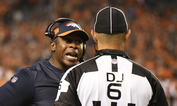 Head coach Vance Joseph of the Denver Broncos talks with a referee during the fourth quarter agains...