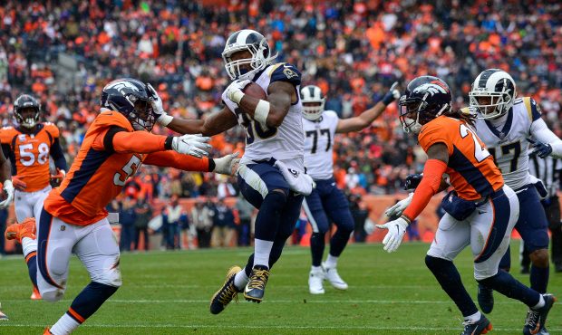 Running back Todd Gurley #30 of the Los Angeles Rams scores a second quarter rushing touchdown as l...