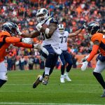 Running back Todd Gurley #30 of the Los Angeles Rams scores a second quarter rushing touchdown as linebacker Todd Davis #51 of the Denver Broncos attempts to tackle him during a game at Broncos Stadium at Mile High on October 14, 2018 in Denver, Colorado. (Photo by Dustin Bradford/Getty Images)