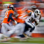 Running back Todd Gurley II #30 of the Los Angeles Rams runs with the football while being chased by cornerback Tramaine Brock #22 of the Denver Broncos during the second quarter at Broncos Stadium at Mile High on October 14, 2018 in Denver, Colorado. (Photo by Justin Edmonds/Getty Images)