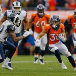 Running back Phillip Lindsay #30 of the Denver Broncos runs with the football as safety Lamarcus Joyner #20 of the Los Angeles Rams defends on the play during the fourth quarter at Broncos Stadium at Mile High on October 14, 2018 in Denver, Colorado. The Rams defeated the Broncos 23-20. (Photo by Justin Edmonds/Getty Images)