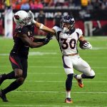 Running back Phillip Lindsay #30 of the Denver Broncos stiff arms cornerback Patrick Peterson #21 of the Arizona Cardinals during the first quarter at State Farm Stadium on October 18, 2018 in Glendale, Arizona. (Photo by Norm Hall/Getty Images)