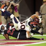Running back Phillip Lindsay #30 of the Denver Broncos scores a 28-yard touchdown over defensive back Bene' Benwikere #23 of the Arizona Cardinals during the third quarter at State Farm Stadium on October 18, 2018 in Glendale, Arizona. (Photo by Christian Petersen/Getty Images)