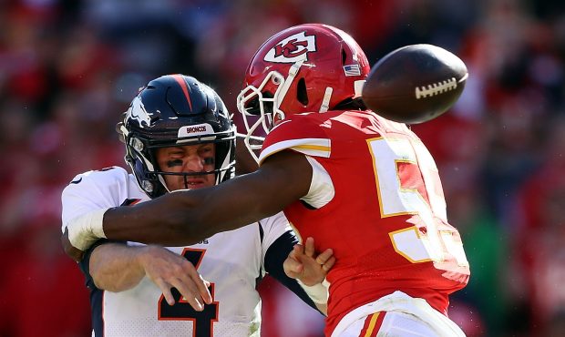 Quarterback Case Keenum #4 of the Denver Broncos loses the ball as he is tackled by linebacker Regg...