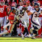 KANSAS CITY, MO - OCTOBER 28: Devontae Booker #23 of the Denver Broncos is tackled along the side line by Su'a Cravens #21 of the Denver Broncos during the second half of the game at Arrowhead Stadium on October 28, 2018 in Kansas City, Missouri. (Photo by Peter Aiken/Getty Images)