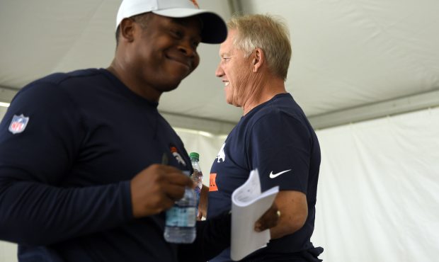 Vance Joseph Head Coach and John Elway President of Football Operations/General Manager pass as the...