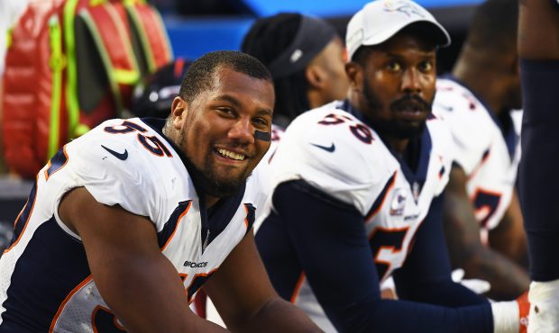 Bradley Chubb #55 of the Denver Broncos smiling on the bench with Von Miller #58 during a strong fi...