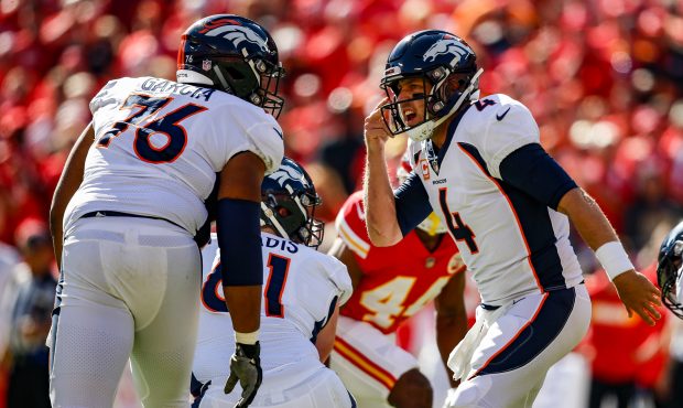 Case Keenum #4 of the Denver Broncos yells a protection call to teammate Max Garcia #76 in deafenin...