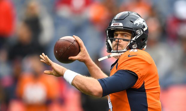 Quarterback Case Keenum #4 of the Denver Broncos throws as he warms up before a game against the Ho...