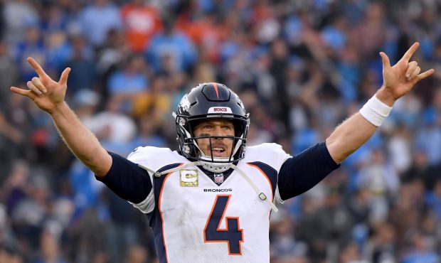 Case Keenum #4 of the Denver Broncos celebrates his completion to set up a game winning field goal ...
