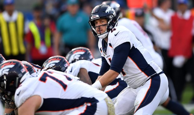 Quarterback Case Keenum #4 of the Denver Broncos at the line in the second half of their win over L...