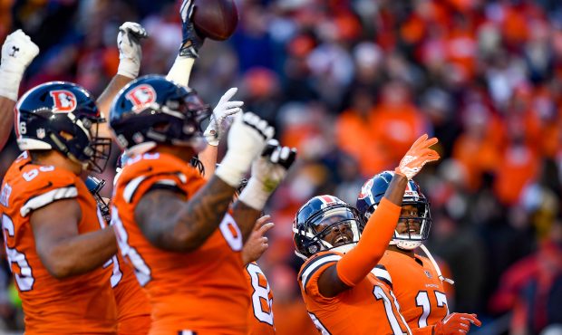 Wide receiver Emmanuel Sanders #10 of the Denver Broncos leads a celebration in the end zone after ...