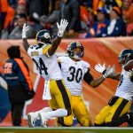 Wide receiver JuJu Smith-Schuster #19 of the Pittsburgh Steelers celebrates with running back James Conner #30 and wide receiver Antonio Brown #84 after a touchdown on a 97 yard catch and run in the third quarter of a game against the Denver Broncos at Broncos Stadium at Mile High on November 25, 2018 in Denver, Colorado. (Photo by Dustin Bradford/Getty Images)
