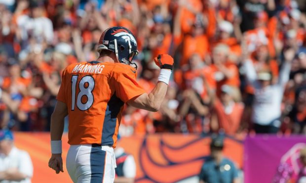 Quarterback Peyton Manning #18 of the Denver Broncos celebrates after passing his 500th career touc...