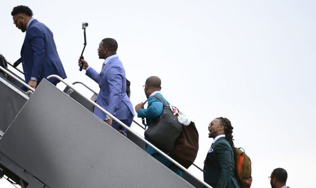 The players climb the stairs to the back of the United plane that will take them to California. The...
