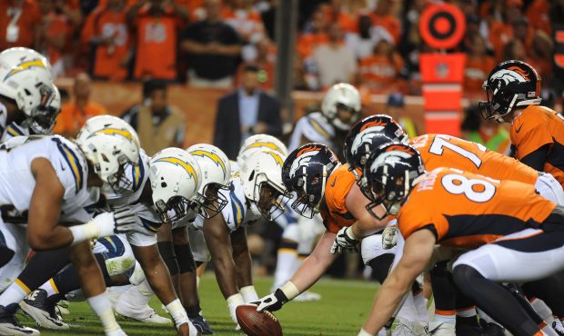 The Denver Broncos offensive line and Los Angeles Chargers defensive lines square off near the goal...