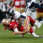 Quarterback Nick Mullens #4 of the San Francisco 49ers is tackled by Will Parks #34 of the Denver Broncos at Levi's Stadium on December 9, 2018 in Santa Clara, California. (Photo by Lachlan Cunningham/Getty Images)