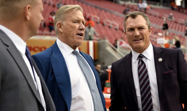 John Elway, general manager of the Denver Broncos, talks with John Lynch, current general manager o...