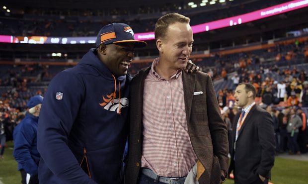 Former Broncos DeMarcus Ware and Peyton Manning laugh on the sideline before the game as the Denver...
