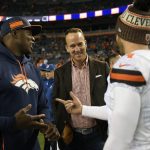 Former Broncos DeMarcus Ware and Peyton Manning talk with Cleveland Browns punter Britton Colquitt (4) before the game as the Denver Broncos played the Cleveland Browns at Broncos Stadium at Mile High. (Photo by Joe Amon/The Denver Post via Getty Images)