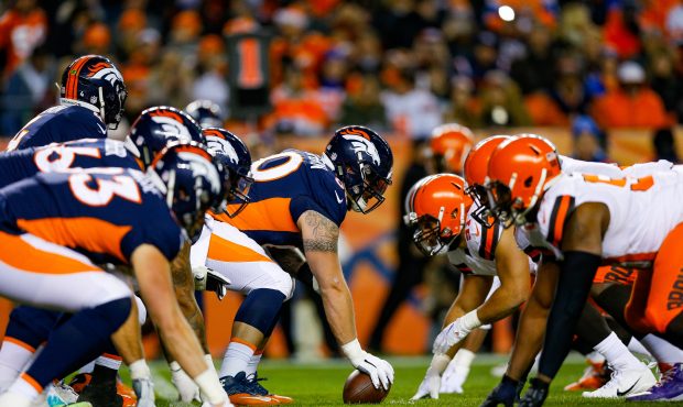 The Denver Broncos offense lines up behind offensive guard Connor McGovern #60 of the Denver Bronco...