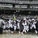 Denver Broncos defense enters the soggy field for warm-ups before playing the Oakland Raiders at the Oakland Alameda Coliseum December 24, 2018. (Photo by Andy Cross/The Denver Post via Getty Images)