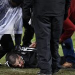 A fan is handcuffed after running onto the field following the NFL game between the Oakland Raiders and the Denver Broncos at Oakland-Alameda County Coliseum on December 24, 2018 in Oakland, California. (Photo by Robert Reiners/Getty Images)