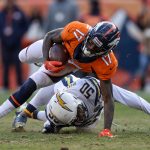 Wide receiver DaeSean Hamilton #17 of the Denver Broncos is tripped up by linebacker Hayes Pullard #50 of the Los Angeles Chargers in the second quarter of a game at Broncos Stadium at Mile High on December 30, 2018 in Denver, Colorado. (Photo by Matthew Stockman/Getty Images)