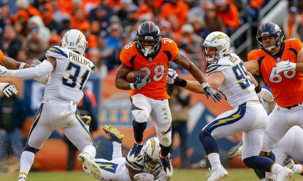 Running back Royce Freeman #28 of the Denver Broncos escapes a tackle attempt by linebacker Hayes P...