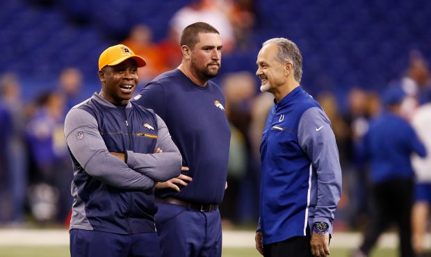 Head coach Vance Joseph of the Denver Broncos talks with head coach Chuck Pagano of the Indianapoli...