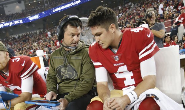 Quarterbacks Coach Rich Scangarello and Nick Mullens #4 of the San Francisco 49ers talk on the side...