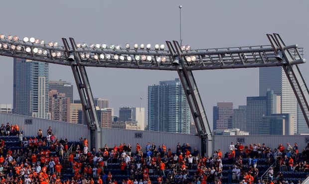 Fans fill the seats of the stadium as the Denver skyline provides the backdrop as the Houston Texan...