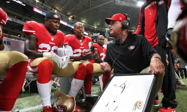 Secondary Coach Ed Donatell of the San Francisco 49ers talks with Tramaine Brock #26 and Carlos Rog...
