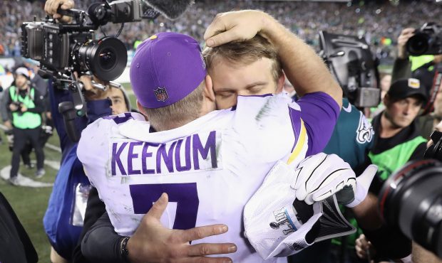 Nick Foles #9 of the Philadelphia Eagles meets with Case Keenum #7 of the Minnesota Vikings after d...