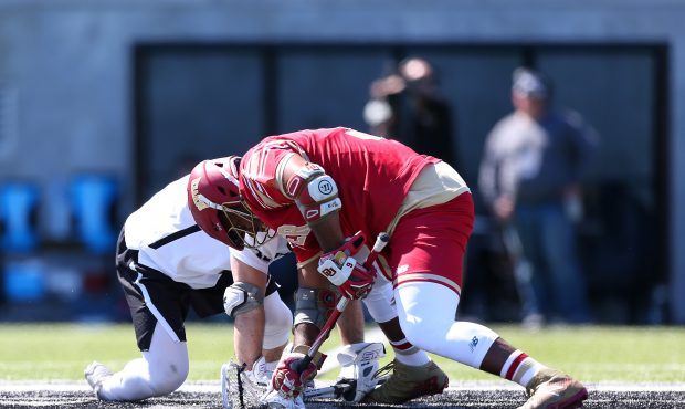 Denver Pioneers face-off Trevor Baptiste (9) and Providence Friars face-off Colin Keating (42) duri...