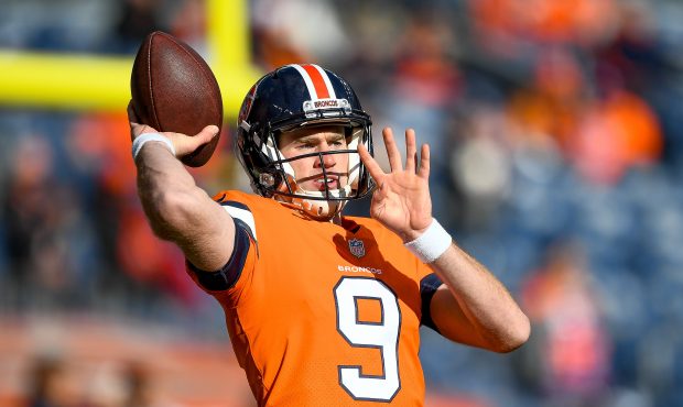 Quarterback Kevin Hogan #9 of the Denver Broncos throws as he warms up before a game against the Pi...