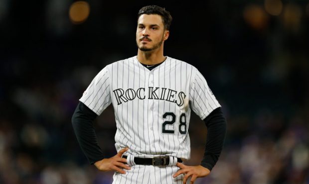 Nolan Arenado #28 of the Colorado Rockies stands on the field after being stranded at third base in...