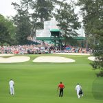 Tony Finau of the United States plays a second shot on the seventh hole as Tiger Woods of the United States looks on during the final round of the Masters at Augusta National Golf Club on April 14, 2019 in Augusta, Georgia. (Photo by Andrew Redington/Getty Images)