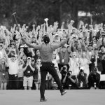 EDITOR'S NOTE: This image has been converted to black and white.) Patrons cheer as Tiger Woods of the United States celebrates after sinking his putt on the 18th green to win during the final round of the Masters at Augusta National Golf Club on April 14, 2019 in Augusta, Georgia. (Photo by David Cannon/Getty Images)