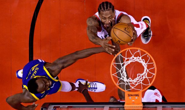 Kawhi Leonard #2 of the Toronto Raptors battles for the rebound with Draymond Green #23 of the Gold...