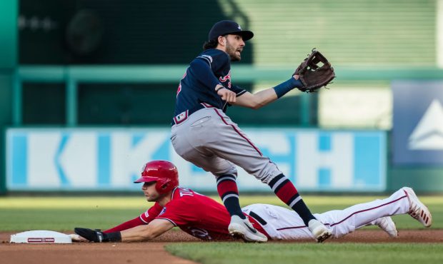 Trea Turner #7 of the Washington Nationals steals second base in front of Dansby Swanson #7 of the ...