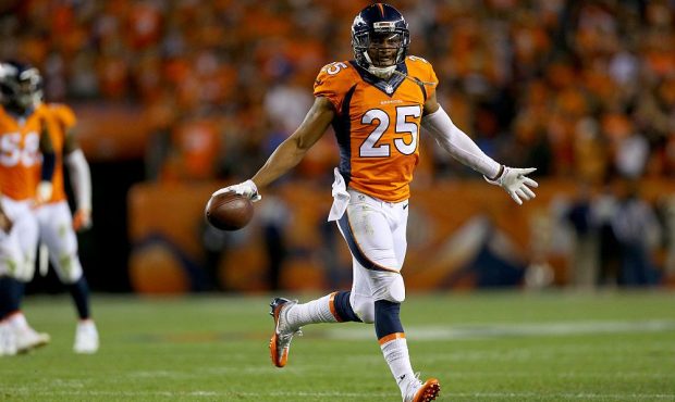 Cornerback Chris Harris #25 of the Denver Broncos celebrates as he intercepts a pass thrown by quar...