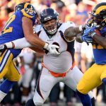 Darrell Henderson #27 of the Los Angeles Rams is stopped for a loss by Mike Purcell #98 of the Denver Broncos during the first half at Los Angeles Memorial Coliseum on August 24, 2019 in Los Angeles, California. (Photo by Harry How/Getty Images)