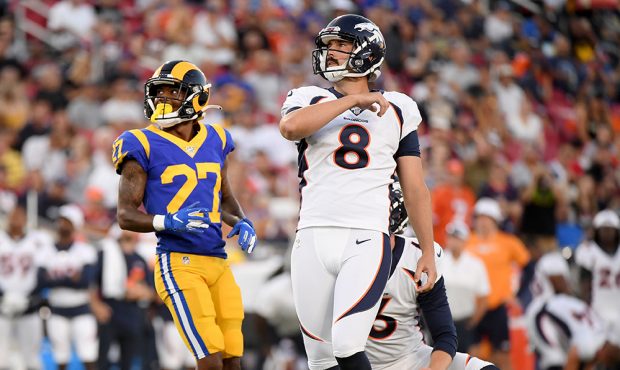 Brandon McManus #8 of the Denver Broncos watches his field goal, to tie the game 3-3, in front of D...